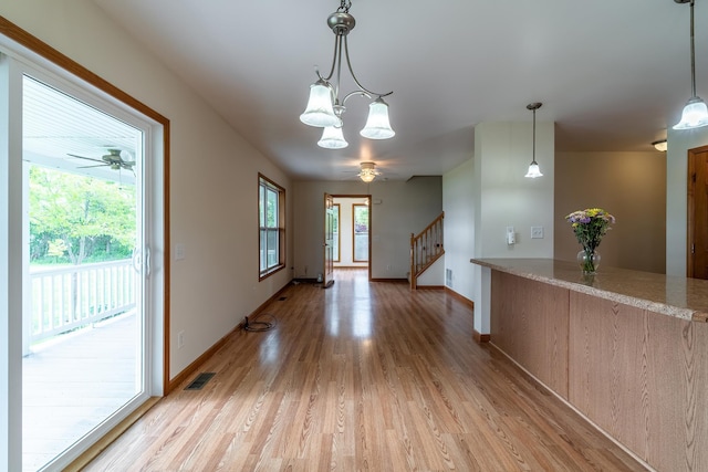 3775 W Columbia St, Columbia City, IN 46725 - unfurnished dining area with light wood finished floors, stairway, baseboards, a ceiling fan, and a chandelier