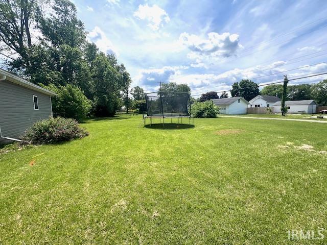 1505 S 3rd St, Clinton, IN 47842 - view of green lawn with a trampoline