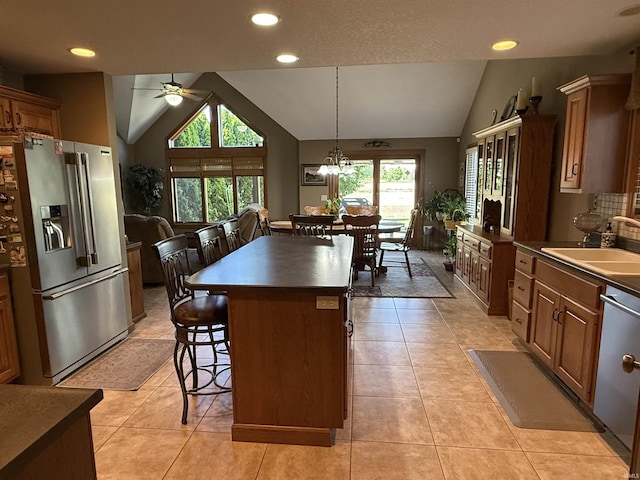 10123 Consta Verde Commons, Leo, IN 46765 - kitchen featuring appliances with stainless steel finishes, lofted ceiling, a sink, a breakfast bar area, and ceiling fan