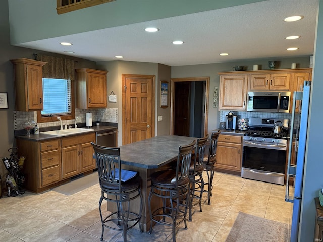 10123 Consta Verde Commons, Leo, IN 46765 - kitchen featuring stainless steel appliances, a sink, dark countertops, backsplash, and recessed lighting