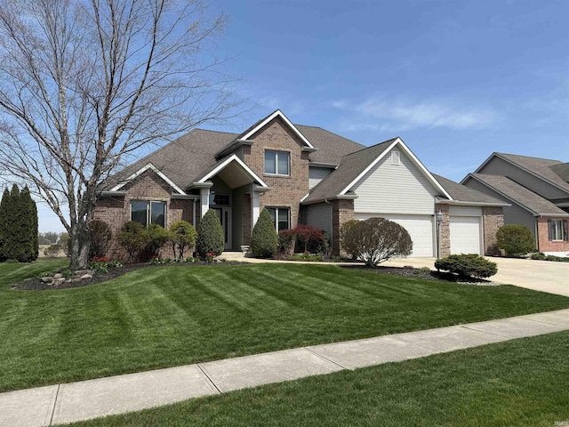10123 Consta Verde Commons, Leo, IN 46765 - view of front facade with brick siding, a front lawn, driveway, and an attached garage