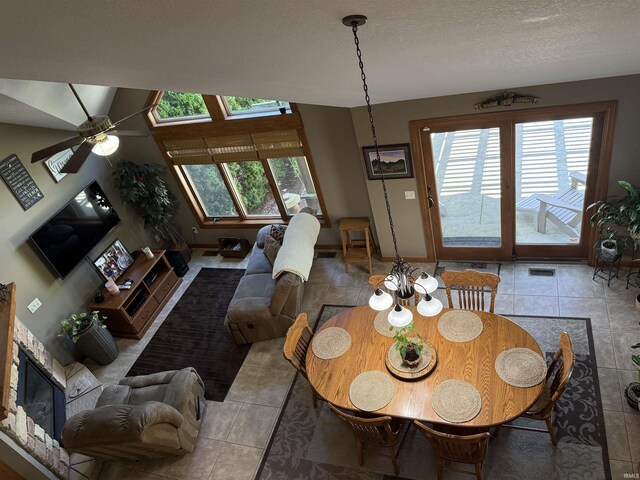 10123 Consta Verde Commons, Leo, IN 46765 - dining room featuring healthy amount of natural light, baseboards, tile patterned floors, ceiling fan, and a textured ceiling