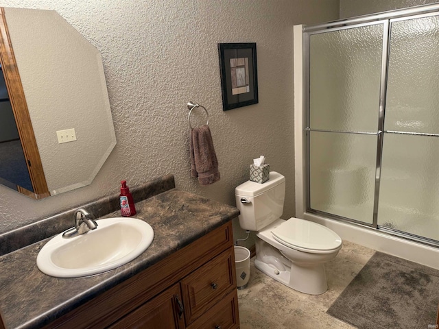 10123 Consta Verde Commons, Leo, IN 46765 - full bath featuring vanity, a shower with shower door, toilet, and a textured wall