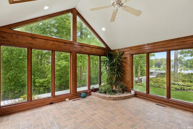 2814 Meadow Strm, Fort Wayne, IN 46825 - unfurnished sunroom featuring lofted ceiling, a water view, brick patterned flooring, recessed lighting, and wooden walls