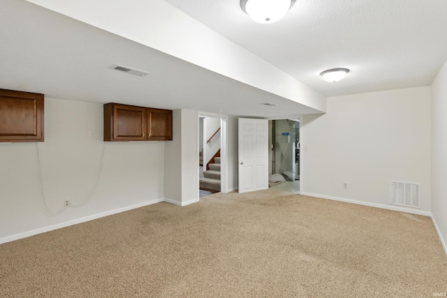 2814 Meadow Strm, Fort Wayne, IN 46825 - finished below grade area featuring light colored carpet, baseboards, and stairs
