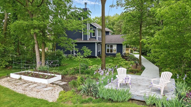 2814 Meadow Strm, Fort Wayne, IN 46825 - view of green lawn with a vegetable garden and a deck