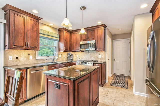 54453 Sagewood Dr, Mishawaka, IN 46545 - kitchen with appliances with stainless steel finishes, a sink, dark stone counters, recessed lighting, and pendant lighting