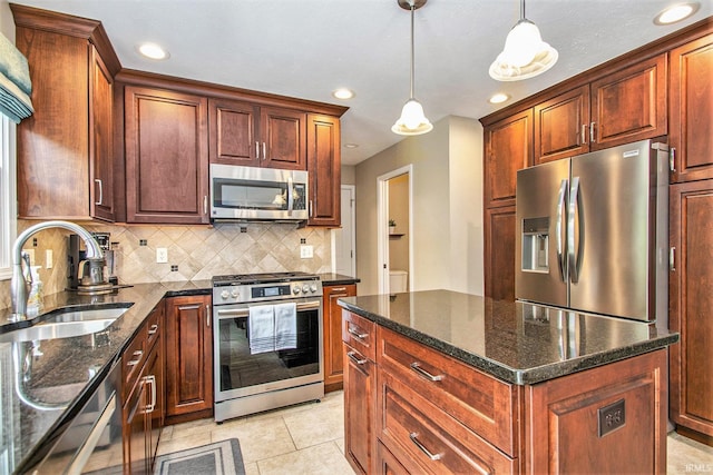 54453 Sagewood Dr, Mishawaka, IN 46545 - kitchen with stainless steel appliances, a sink, decorative backsplash, recessed lighting, and hanging light fixtures