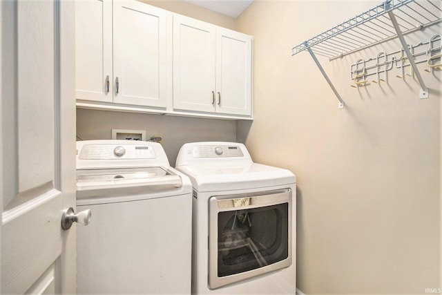 54453 Sagewood Dr, Mishawaka, IN 46545 - laundry area featuring washer and dryer and cabinet space