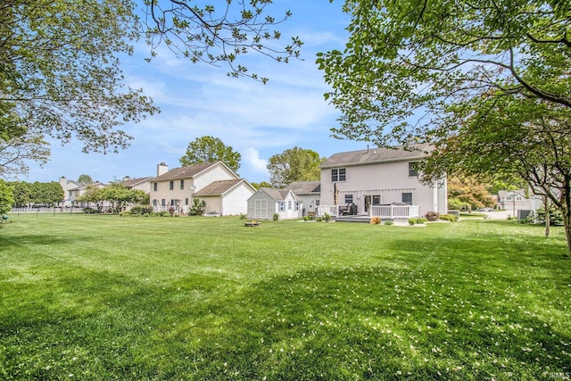 54453 Sagewood Dr, Mishawaka, IN 46545 - view of green lawn with a wooden deck and a residential view