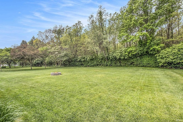 54453 Sagewood Dr, Mishawaka, IN 46545 - view of grassy yard featuring an outdoor fire pit