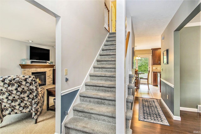 54453 Sagewood Dr, Mishawaka, IN 46545 - stairway featuring wood finished floors, baseboards, and a fireplace