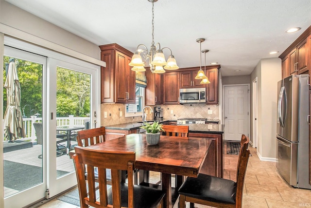 54453 Sagewood Dr, Mishawaka, IN 46545 - kitchen featuring stainless steel appliances, decorative backsplash, baseboards, recessed lighting, and pendant lighting