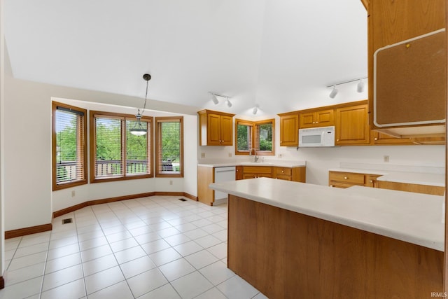 2519 Knightsbridge Dr, Fort Wayne, IN 46815 - kitchen with track lighting, white appliances, brown cabinetry, decorative light fixtures, and vaulted ceiling