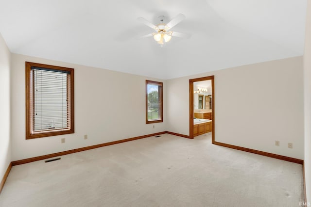 2519 Knightsbridge Dr, Fort Wayne, IN 46815 - spare room with light carpet, baseboards, vaulted ceiling, and ceiling fan