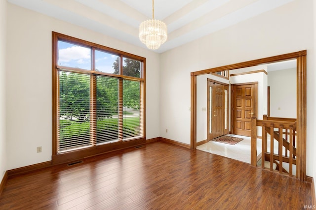 2519 Knightsbridge Dr, Fort Wayne, IN 46815 - spare room with a chandelier, wood finished floors, and baseboards