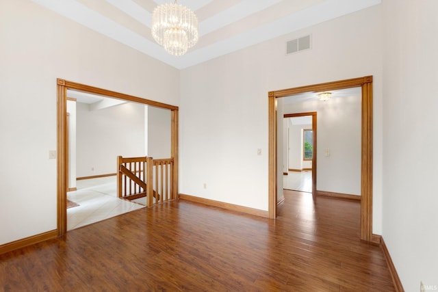 2519 Knightsbridge Dr, Fort Wayne, IN 46815 - empty room featuring wood finished floors, a chandelier, and baseboards