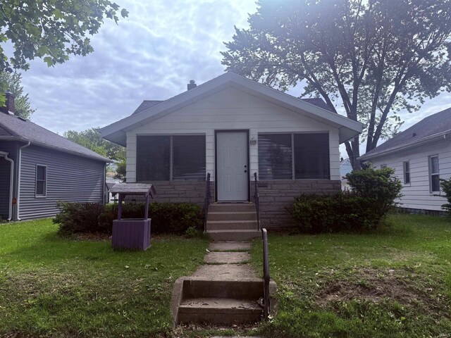 626 S 24th St, South Bend, IN 46615 - bungalow-style house featuring a front yard, stone siding, and entry steps