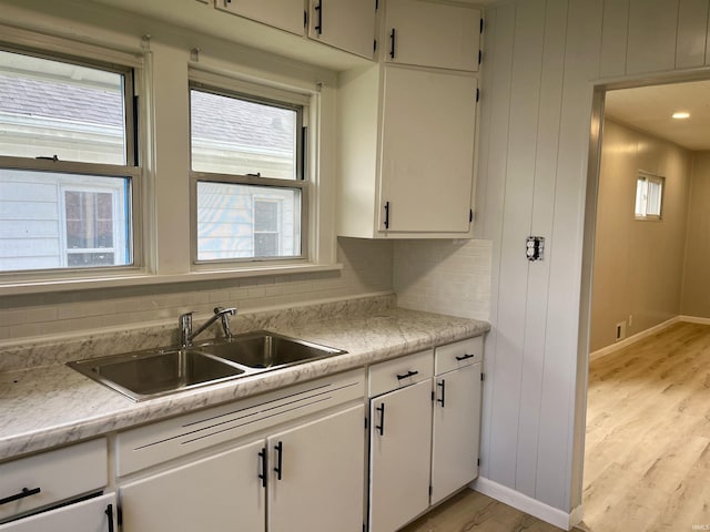 626 S 24th St, South Bend, IN 46615 - kitchen featuring a sink, light countertops, light wood-style floors, and white cabinets