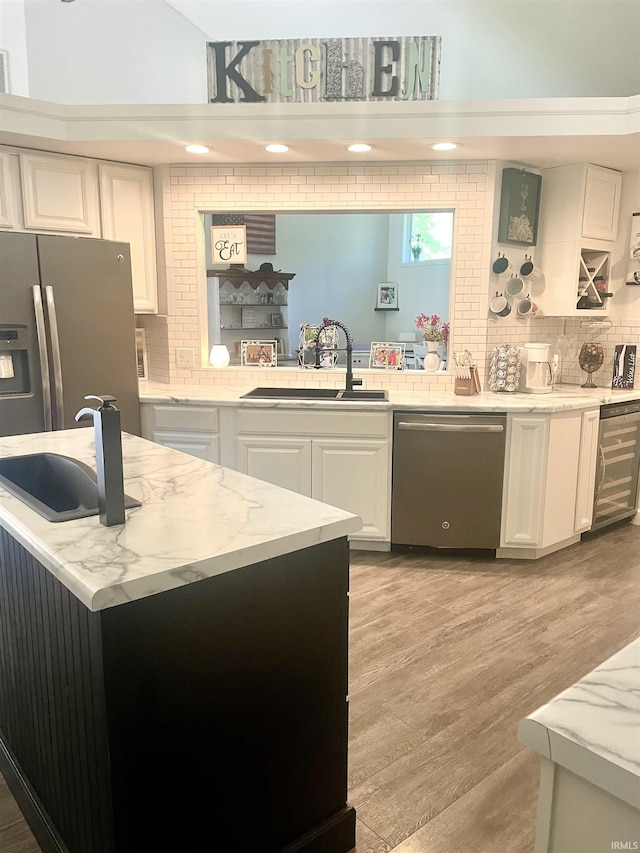 853 S 400 E Rd, Marion, IN 46953 - kitchen with appliances with stainless steel finishes, a sink, backsplash, and white cabinets