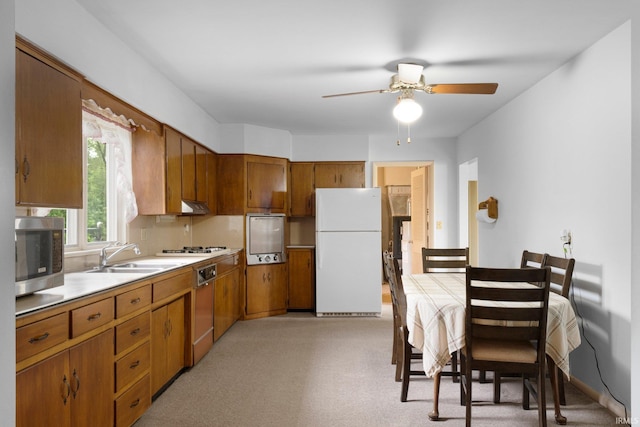 213 S Clark St, Auburn, IN 46706 - kitchen with white appliances, a sink, brown cabinetry, and light countertops