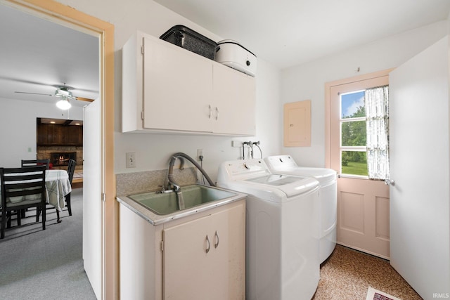 213 S Clark St, Auburn, IN 46706 - laundry room with cabinet space, washing machine and clothes dryer, a warm lit fireplace, electric panel, and ceiling fan