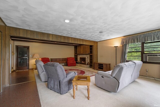 213 S Clark St, Auburn, IN 46706 - living room with wood walls, a warm lit fireplace, baseboards, a textured ceiling, and cooling unit
