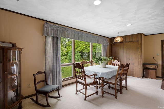 213 S Clark St, Auburn, IN 46706 - dining space with healthy amount of natural light, light colored carpet, ornamental molding, and baseboards