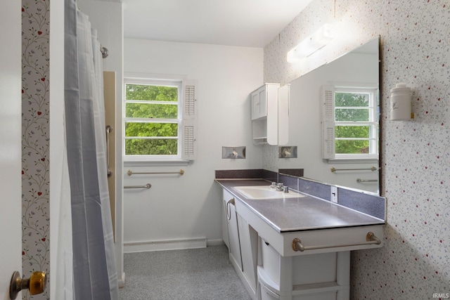 213 S Clark St, Auburn, IN 46706 - full bathroom with plenty of natural light, a baseboard heating unit, vanity, and baseboards