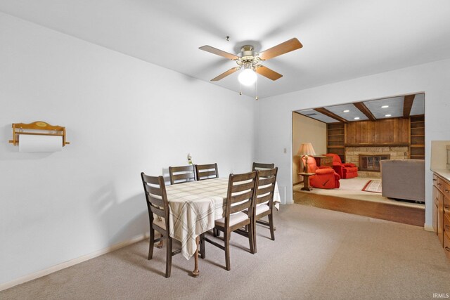 213 S Clark St, Auburn, IN 46706 - dining area with a glass covered fireplace, light colored carpet, recessed lighting, a ceiling fan, and baseboards