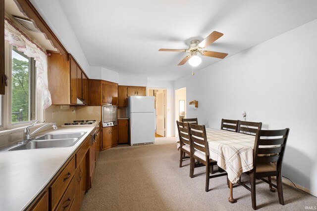 213 S Clark St, Auburn, IN 46706 - kitchen with white appliances, a sink, light carpet, a ceiling fan, and brown cabinetry