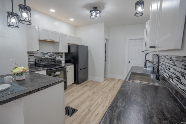 103 W US-24 Hwy, Idaville, IN 47950 - kitchen featuring black appliances, tasteful backsplash, light wood-style flooring, white cabinets, and recessed lighting