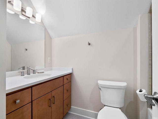 6138 E Elwood St, Syracuse, IN 46567 - bathroom with vanity, vaulted ceiling, toilet, and baseboards