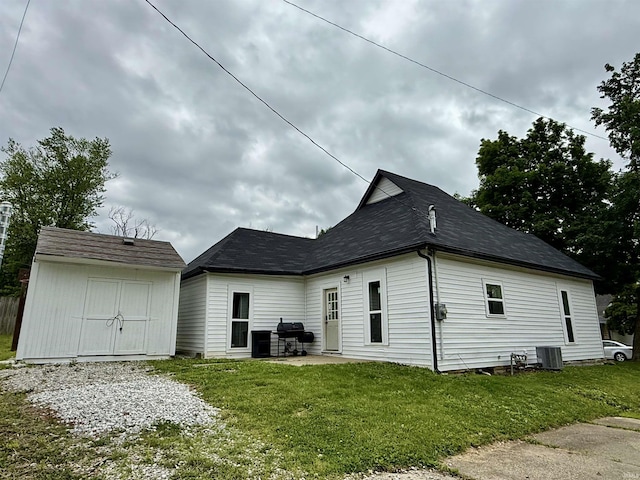 302 L St, Bedford, IN 47421 - view of side of home with central AC, a lawn, and a patio area