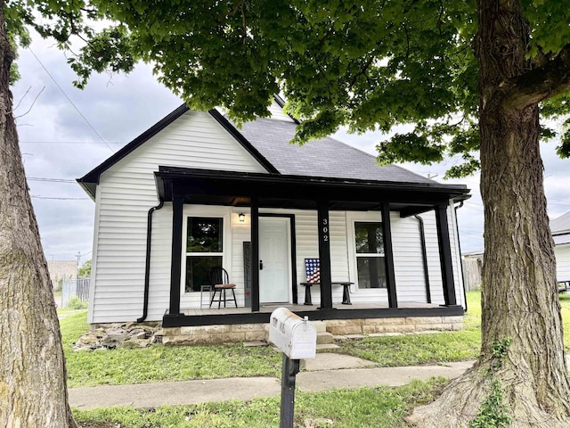 302 L St, Bedford, IN 47421 - view of front of house featuring covered porch and roof with shingles
