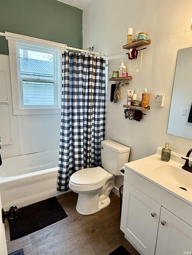 302 L St, Bedford, IN 47421 - bathroom with toilet, wood finished floors, vanity, and shower / bath combo with shower curtain
