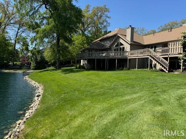 2525 Ladue Cv, Fort Wayne, IN 46804 - view of green lawn featuring a deck with water view and stairs