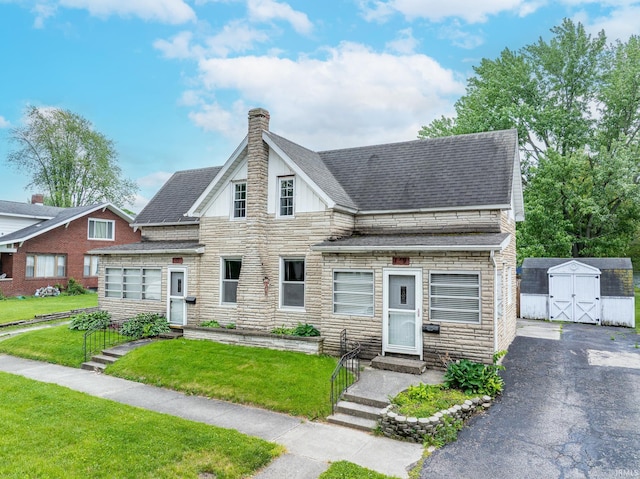139 Elm St, Wabash, IN 46992 - view of front facade featuring stone siding, a shingled roof, a chimney, and entry steps