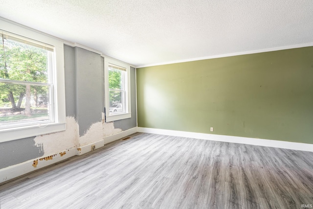 139 Elm St, Wabash, IN 46992 - unfurnished room featuring wood finished floors, a textured ceiling, plenty of natural light, and baseboards