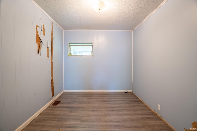 139 Elm St, Wabash, IN 46992 - unfurnished room with a textured ceiling, wood finished floors, baseboards, and crown molding