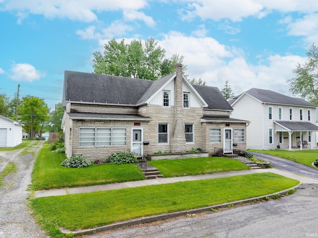 139 Elm St, Wabash, IN 46992 - view of front of house with stone siding, a chimney, a shingled roof, and a front lawn