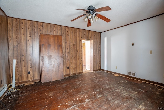139 Elm St, Wabash, IN 46992 - unfurnished room featuring a ceiling fan, crown molding, wood walls, and baseboards