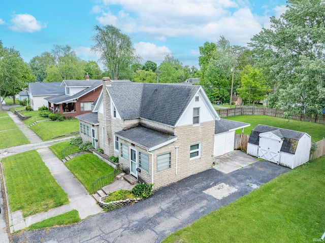 139 Elm St, Wabash, IN 46992 - view of side of property featuring roof with shingles, driveway, stone siding, and a chimney