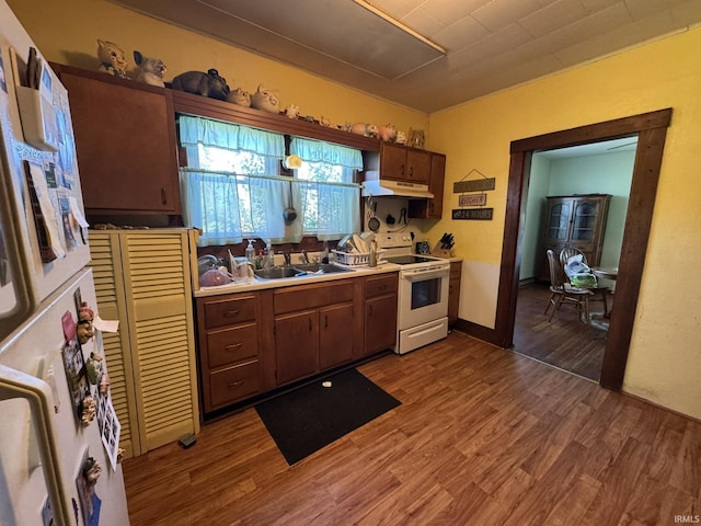 8595 W 1000 S Unit 35, Lafontaine, IN 46940 - kitchen with white appliances, under cabinet range hood, wood finished floors, and light countertops