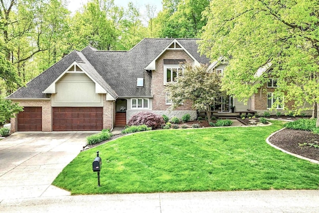10919 Running Tide Ct, Indianapolis, IN 46236 - view of front facade featuring a front yard, brick siding, an attached garage, driveway, and a shingled roof