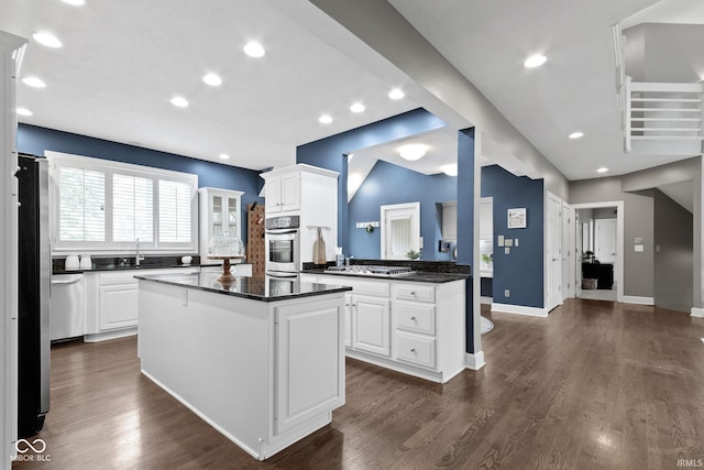 10919 Running Tide Ct, Indianapolis, IN 46236 - kitchen featuring dark countertops, a sink, white cabinets, a kitchen island, and recessed lighting
