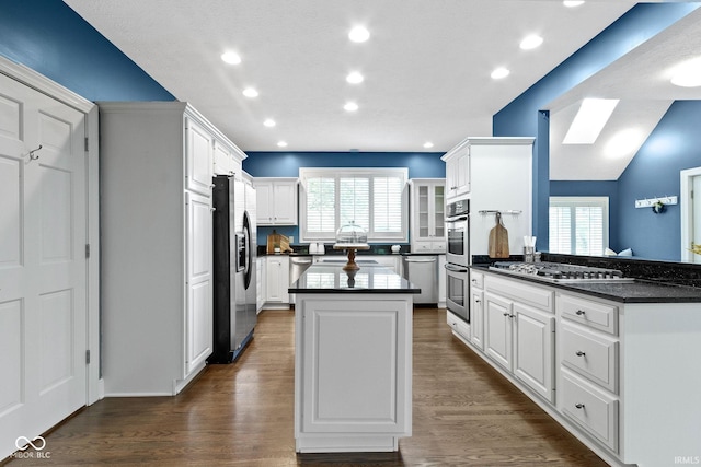 10919 Running Tide Ct, Indianapolis, IN 46236 - kitchen featuring appliances with stainless steel finishes, dark countertops, a kitchen island, healthy amount of natural light, and recessed lighting