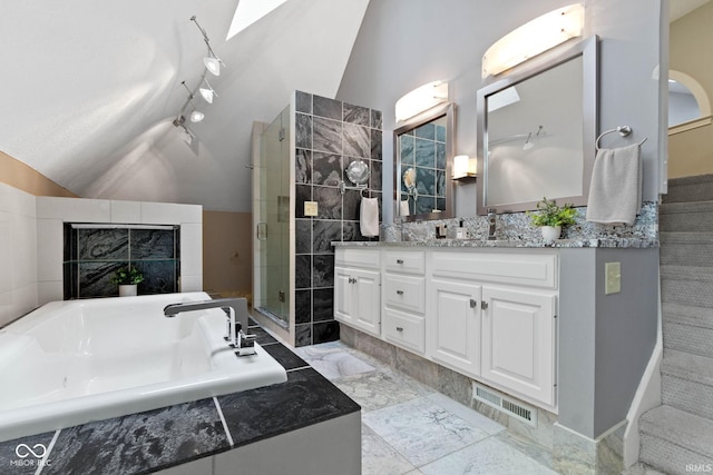 10919 Running Tide Ct, Indianapolis, IN 46236 - full bath with lofted ceiling, double vanity, a stall shower, a garden tub, and rail lighting