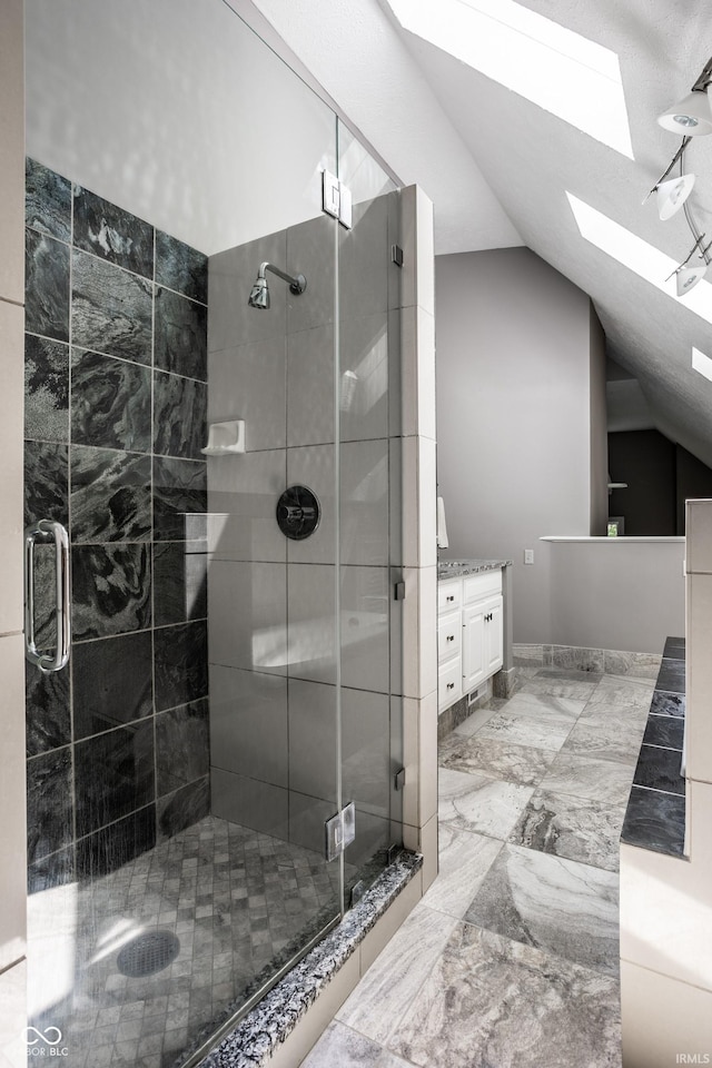 10919 Running Tide Ct, Indianapolis, IN 46236 - bathroom featuring a skylight, lofted ceiling, vanity, a shower stall, and marble finish flooring