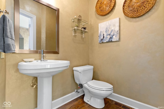 10919 Running Tide Ct, Indianapolis, IN 46236 - half bathroom featuring toilet, wood finished floors, and baseboards